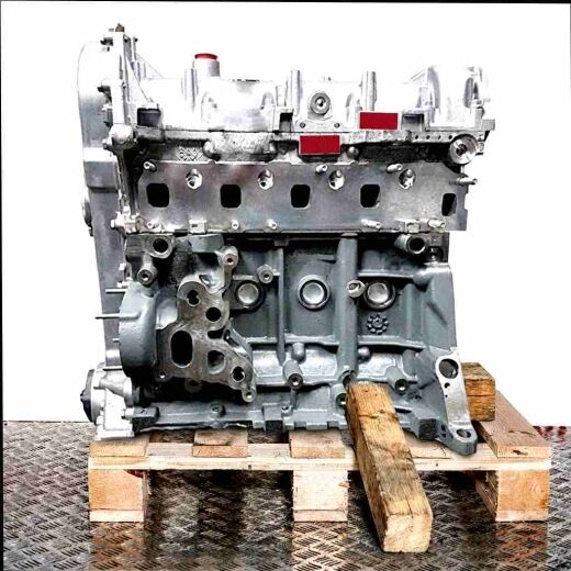Engine 199 A2.000 on a wooden pallet against a white background. The engine, composed mainly of silver and gray metal parts, is viewed from the side.