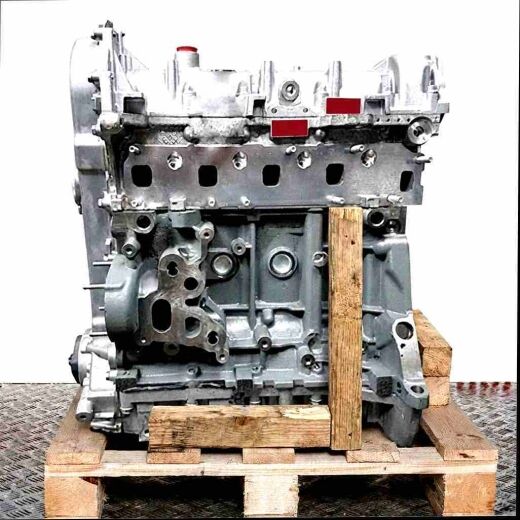 Engine block 330 A1.000 in grey on a wooden pallet against a white background. Side view showcasing various connection points and boreholes.