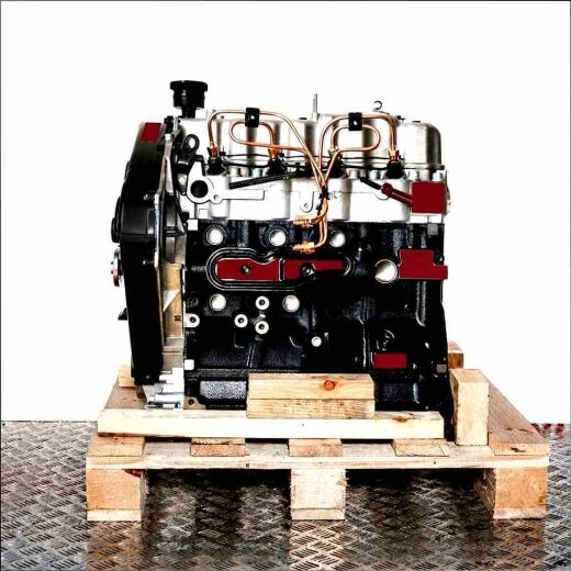Black and silver 4D56-TD engine on a wooden pallet against a white background. The engine is straight.