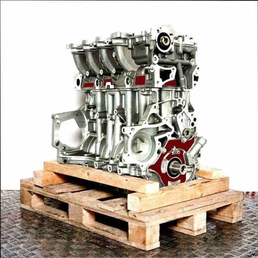 Gray-silver engine block 9HU (DV6UTED4) on a wooden pallet against a white background. The engine, featuring a black oil pan, is captured from a slightly angled side view.