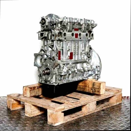 Engine 9HX on a wooden pallet against a white background. The engine is composed primarily of silver metal parts and a black oil pan.