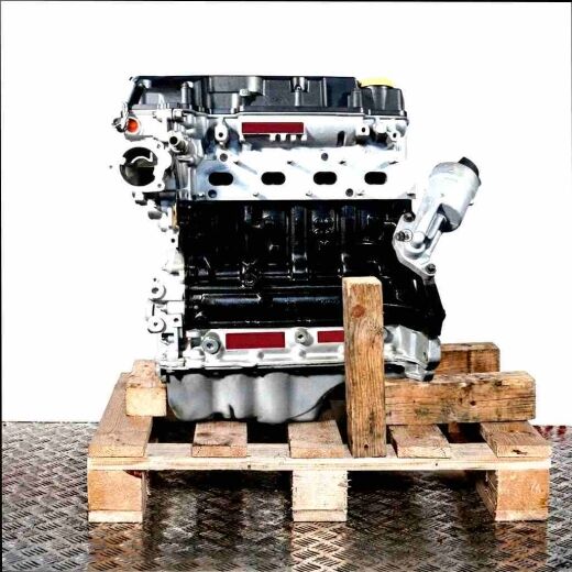 A 12 XEL engine on a wooden pallet against a white background. The silver and black engine is displayed from the side.