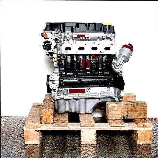 A 12 XER engine on a wooden pallet against a white background. The silver and black engine is shown from the side.