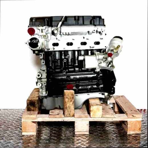 A 14 NET engine in black and silver on a wooden pallet against a white background. Side view of the engine with yellow accents.