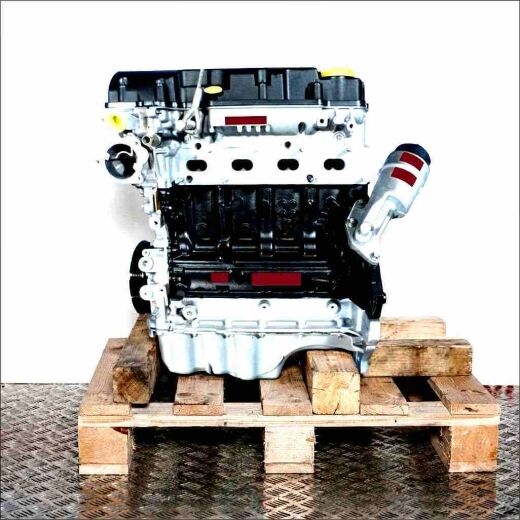 A 14 XER engine on a wooden pallet against a white background. The silver and black engine with yellow and blue accents is shown from a side, slightly front angle.