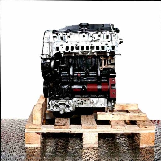 Side view of engine ABFA on a wooden pallet against a white background. The upper part is silver, the lower part is dark grey.