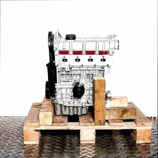 Side view of the AKQ engine on a wooden pallet against a white background. The metal and black engine is fully visible.