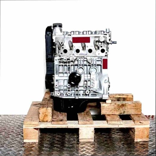 Side view of a grey APQ engine on a wooden pallet against a white background. The engine features black components and shiny metal parts.