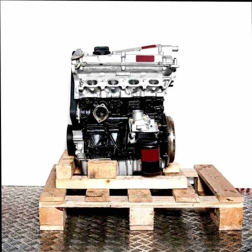 Side view of an APX engine in silver and black on a wooden pallet. The engine is set against a white background and features an oil filter.