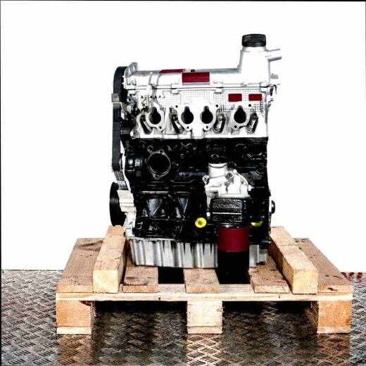 Side view of engine AZJ on a wooden pallet against a white background. The silver and black engine displays belts and pipes.