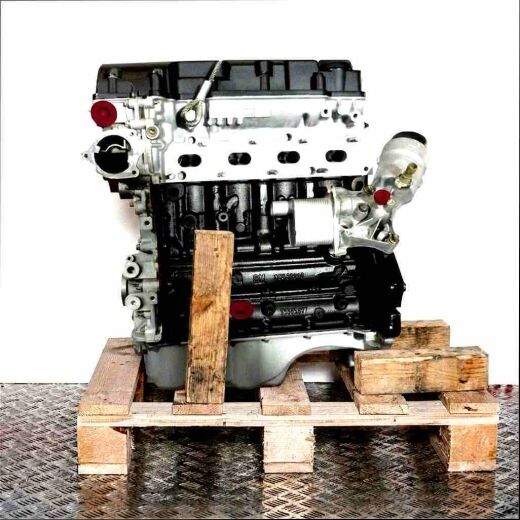 B 14 NET engine in black and silver on a wooden pallet against a white background. Yellow caps visible. Side view.