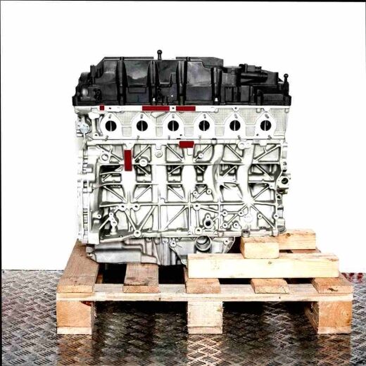 B57 D30 A engine on a wooden pallet against a white background. Side view of the silver engine with a black cover.