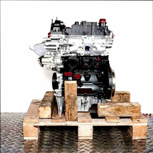 B7DA engine on a wooden pallet against a white background. The silver and black engine with yellow accents is viewed from the side.