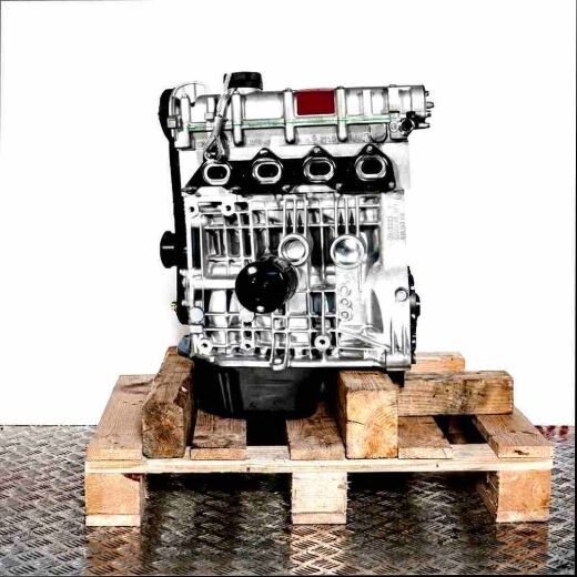 Side view of a silver BBY engine on a wooden pallet against a white background. Features include an oil filter and belt.