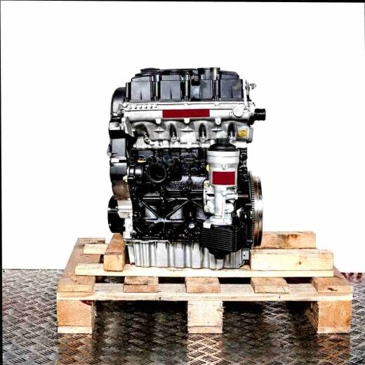 Black and silver BMP engine on a wooden pallet against a white background. Side view of the engine, vertically aligned.
