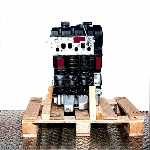 BMS engine on a wooden pallet against a white background. The engine, featuring black and silver components, is vertically oriented.