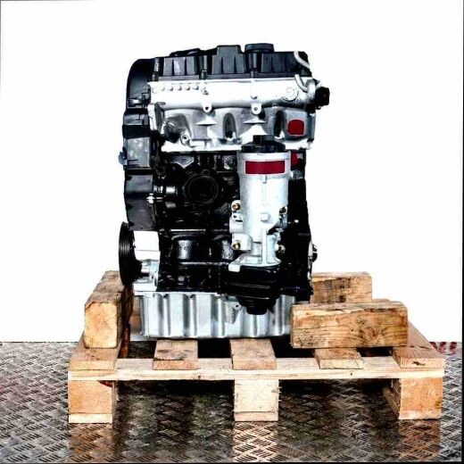 Side view of a black and silver BNM engine on a wooden pallet. The engine is set against a white background.