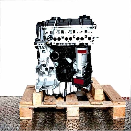 BRE engine on wooden pallet against a white background. Black and silver car engine, vertical view.