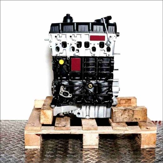 Black and silver BUK engine on a wooden pallet against a white background. The engine is fully visible, with some parts in a plastic bag.