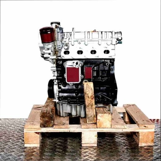 Side view of a BWK engine on a wooden pallet against a white background. The silver top and black bottom of the engine are visible, along with the oil filter. The oil pan is silver.