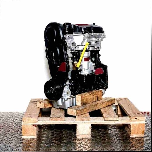 BXF engine on a wooden pallet against a white background. Side view of the black and silver engine with a yellow accent.