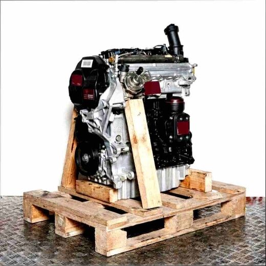 Side view of a black and silver engine (CAAD) on a wooden pallet. The engine is set against a white background.