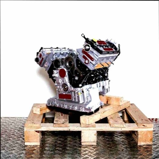 CAPA engine in grey tones on a wooden pallet against a white background. Side view of the engine.