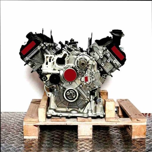 Front view of a CASA engine on a wooden pallet against a white background. The silver and black engine is isolated.