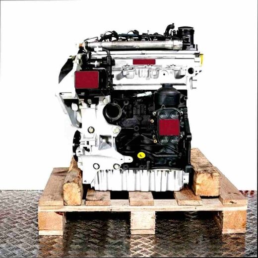 Side view of a CAYB engine on a wooden pallet against a white background. The silver and black engine displays details like fuel injectors and lines.