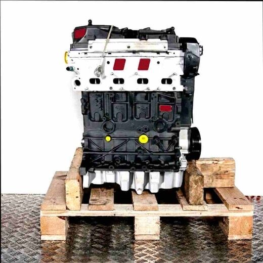 CAYC engine on a wooden pallet against a white background. The black and light grey engine features numerous round openings and yellow elements. Front view.