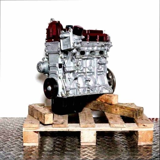 CBZA engine on a wooden pallet against a white background. The silver engine with black components and oil pan is vertically oriented.