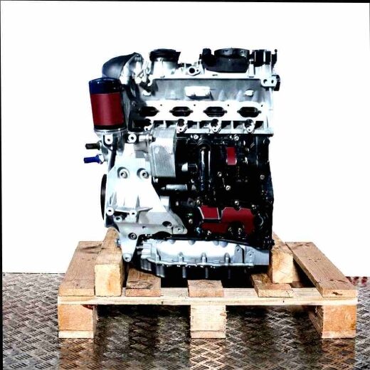 Side view of a CCZB engine on a wooden pallet against a white background. The engine is composed primarily of silver and black components.