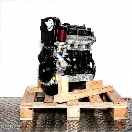 CDNB engine on a wooden pallet against a white background. Black and silver design with yellow accents. Vertical orientation.