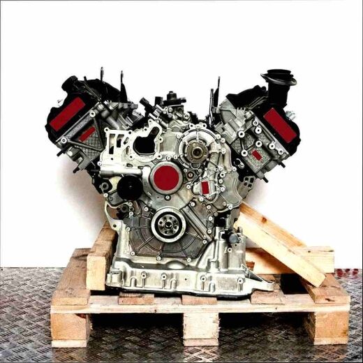 CDTA V8 engine on a wooden pallet against a white background. Detailed shot of the silver and black engine.