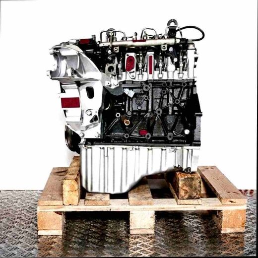 Side view of a CEBB engine on a wooden pallet against a white background. The engine, featuring black and silver components, is vertically oriented.