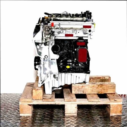 CKTC engine on a wooden pallet against a white background. The silver and black engine is viewed from the side, showcasing hoses and connectors.