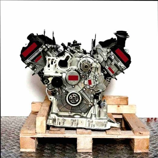 CKVC engine on a wooden pallet against a white background. The V-shaped engine with gray and black components is fully visible.