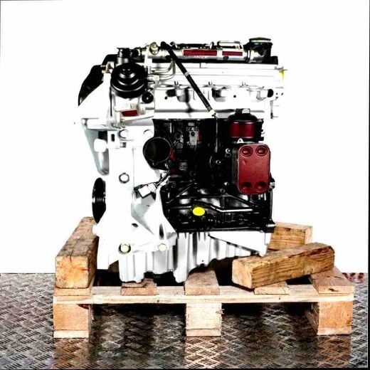 Side view of a CMGB car engine on a wooden pallet against a white background. The engine, in black, silver, and yellow, is positioned vertically.