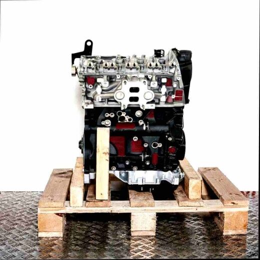 CVKB engine on a wooden pallet against a white background. This image displays a silver and black engine, showcasing the cylinder head and engine block. Side view.