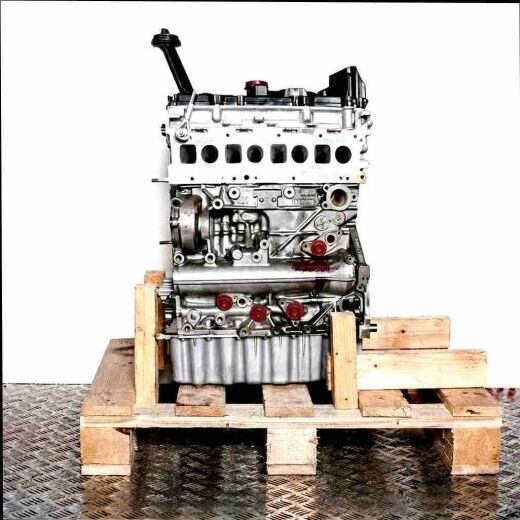 CXEB engine on a wooden pallet against a white background. The black and silver engine with yellow accents is viewed from the side.
