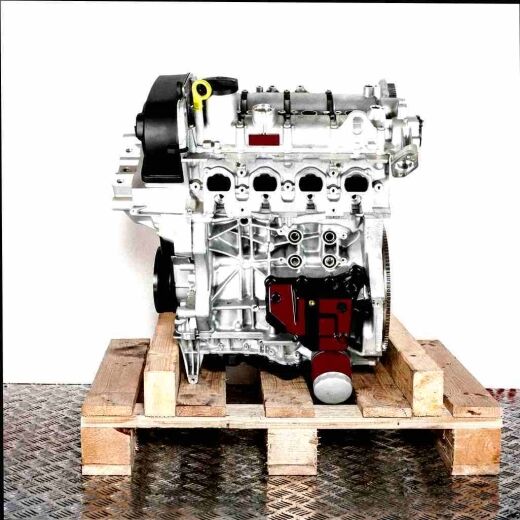 CZCA engine block on a wooden pallet against a white background. Silver engine with black and yellow parts, front view.