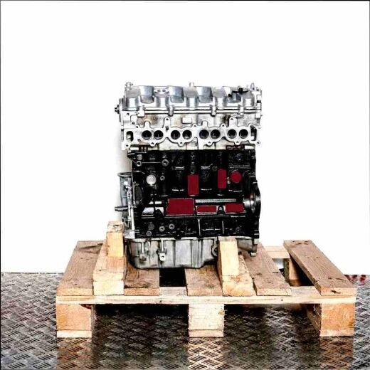 D4EB engine on a wooden pallet against a white background. The silver and black engine is viewed from a slightly elevated side angle.