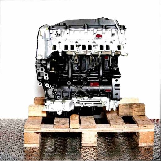 D4FA engine on a wooden pallet against a white background. The black and silver engine is viewed from the front.