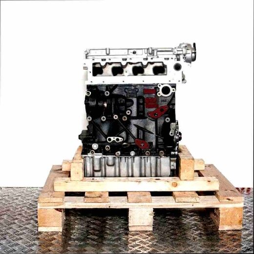 DCXA engine on a wooden pallet against a white background. Side view of the engine, no watermarks or logos.