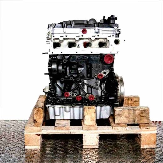 DDYA engine on a wooden pallet against a white background. The black engine block with silver cylinder head and oil pan features yellow covers.