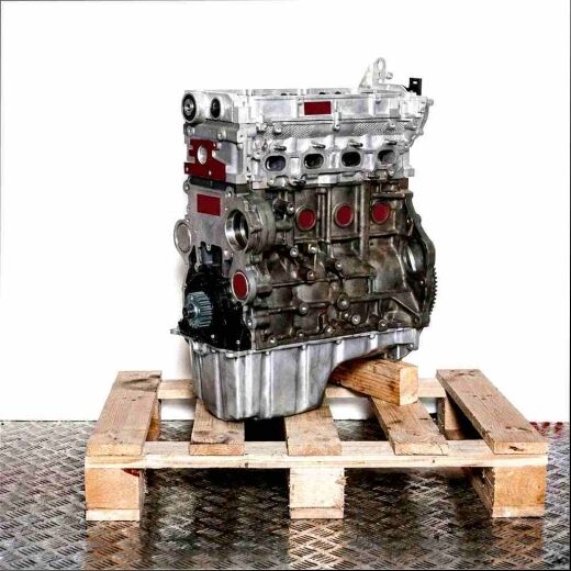 Side view of a DEUA engine on a wooden pallet against a white background. The engine, with its silver top and dark bottom visible, showcases gears.