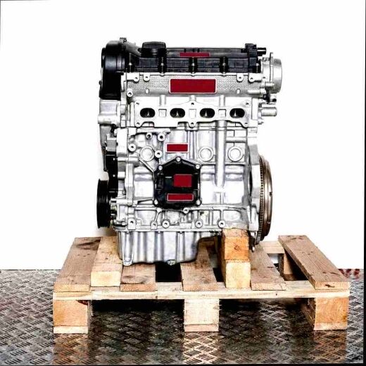 Silver engine DKRF on a wooden pallet against a white background. The engine, featuring black and yellow details, is displayed from the side.
