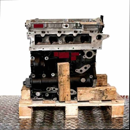 Side view of a black and silver DLTA engine on a wooden pallet against a white background. The engine is vertically oriented.