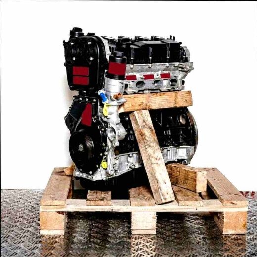 DNUE engine on a wooden pallet against a white background. Side view, slightly from the front right.