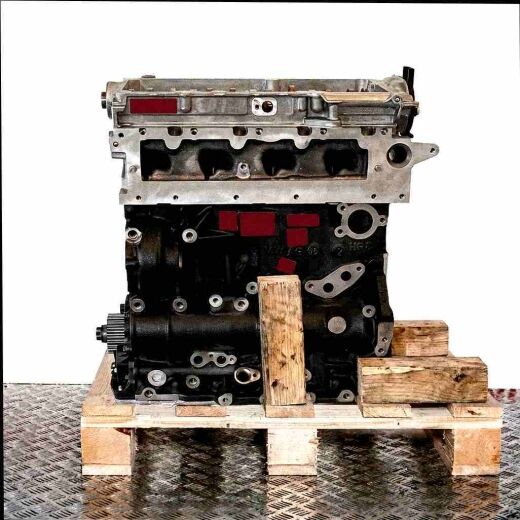 DTTC engine on a wooden pallet against a white background. The black engine block and silver components are fully visible.